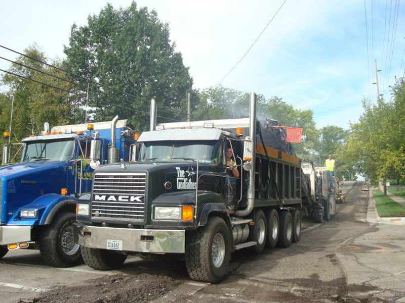 Mack trucks working on road