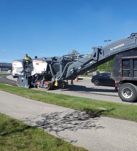 Pulverized road being loaded into truck